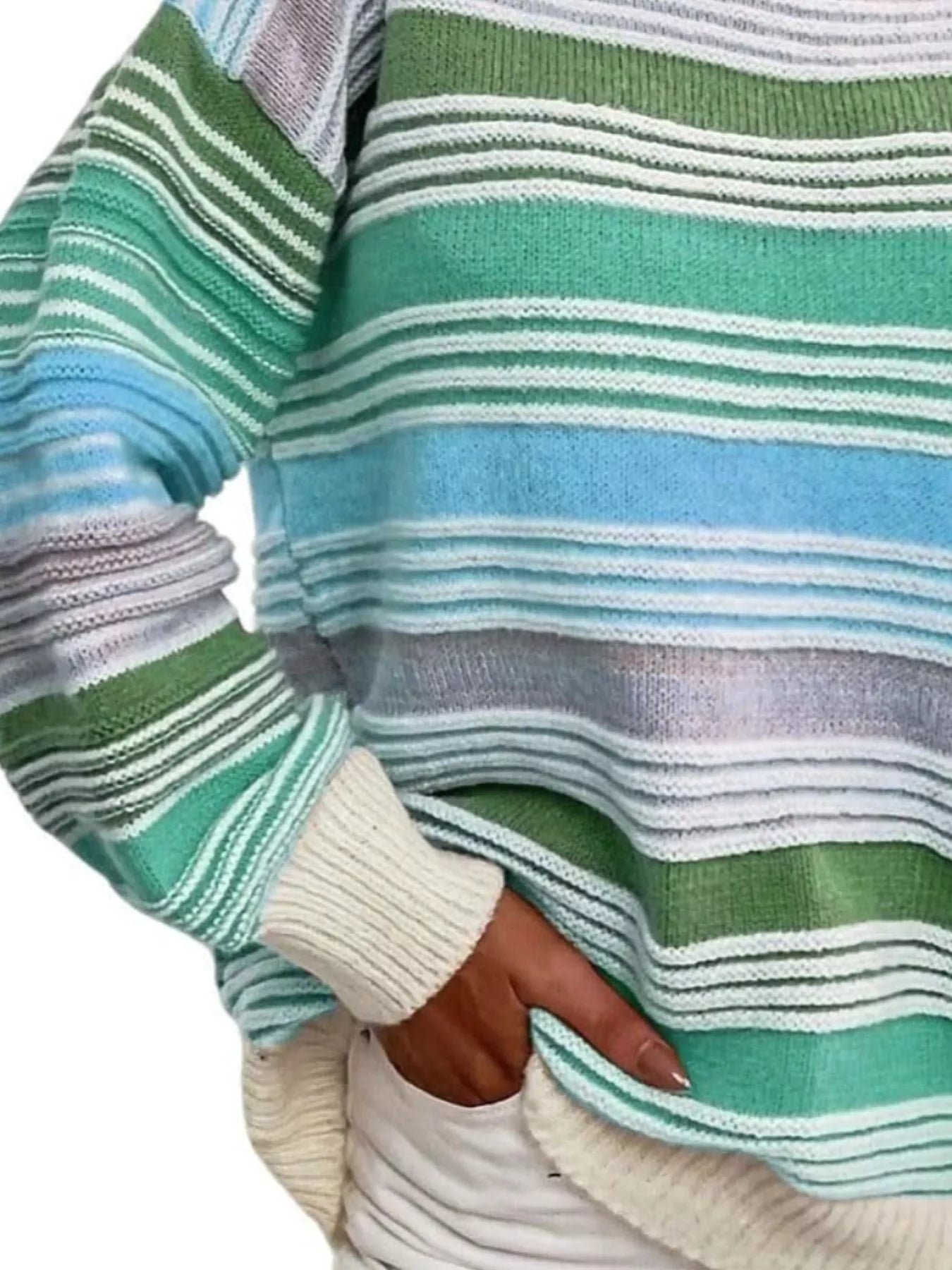 Close-up of a person wearing a striped sweater with green, blue, and white colors.