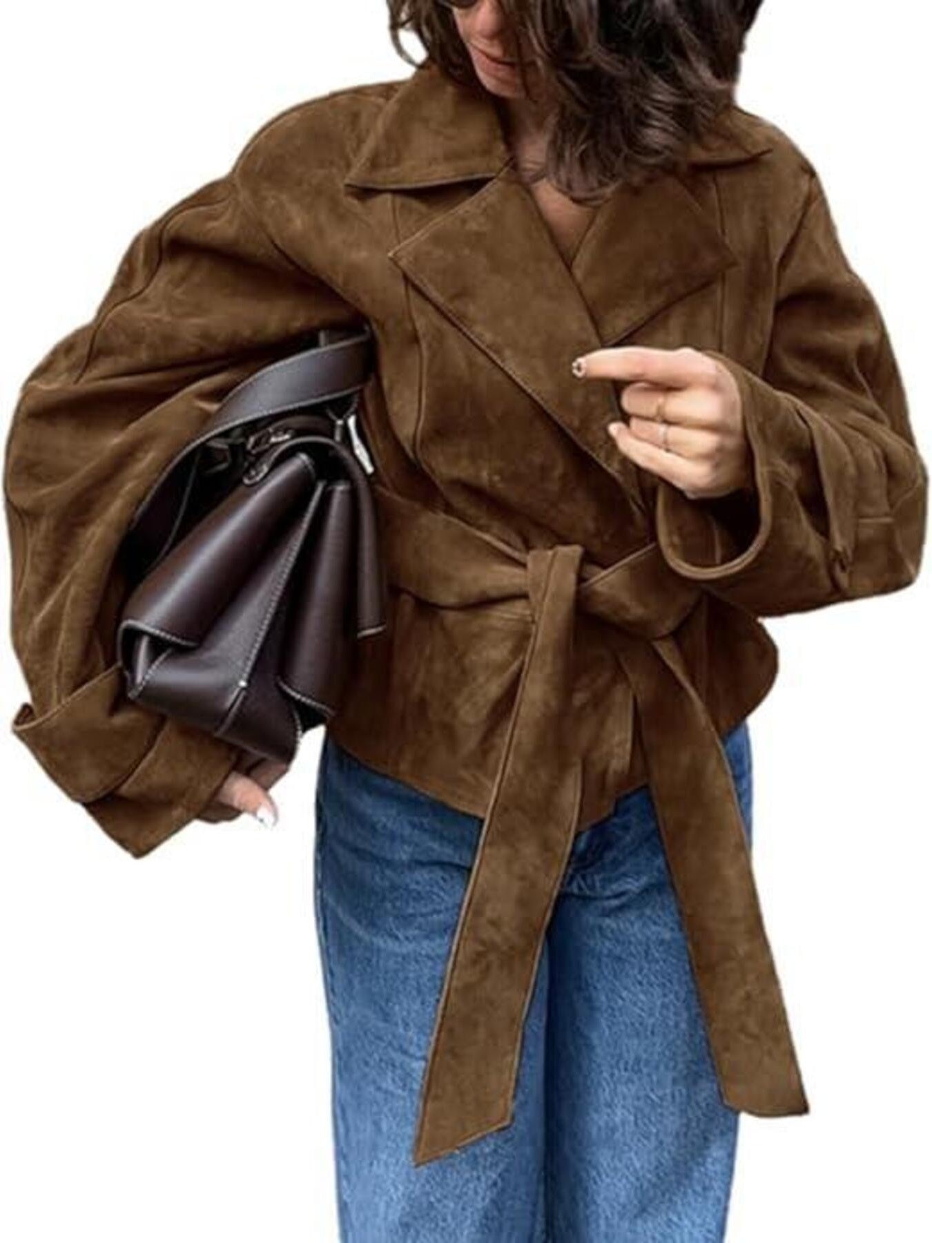 Person wearing a brown suede jacket holding a matching handbag on a white background