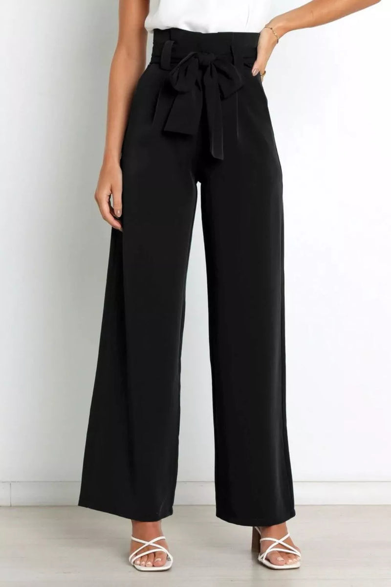 Black wide-leg pants with a tie waist worn by a person on a white background