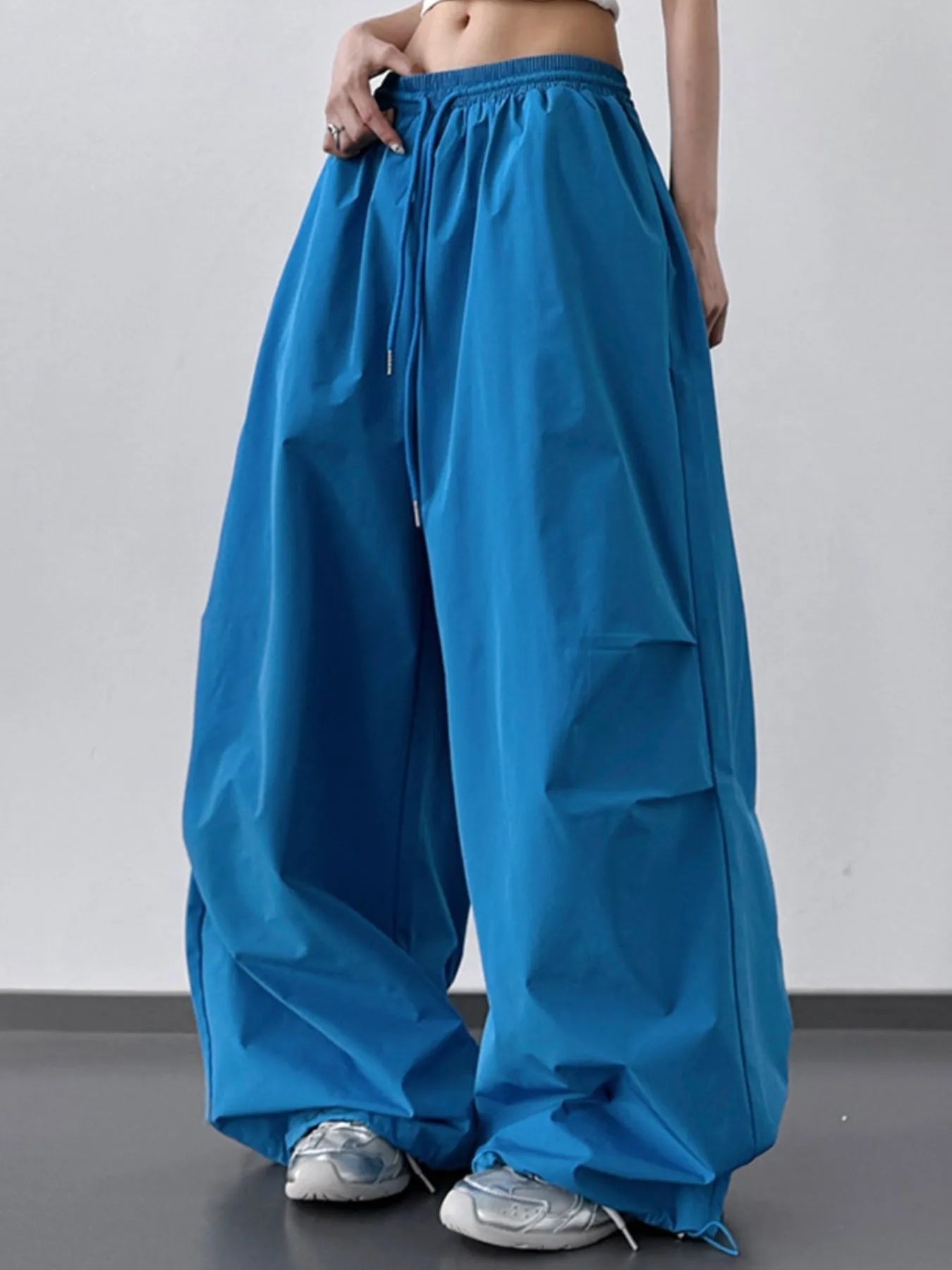 Blue wide-leg pants worn by a person on a plain background