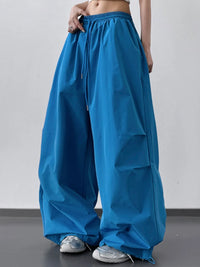 Blue wide-leg pants worn by a person on a plain background
