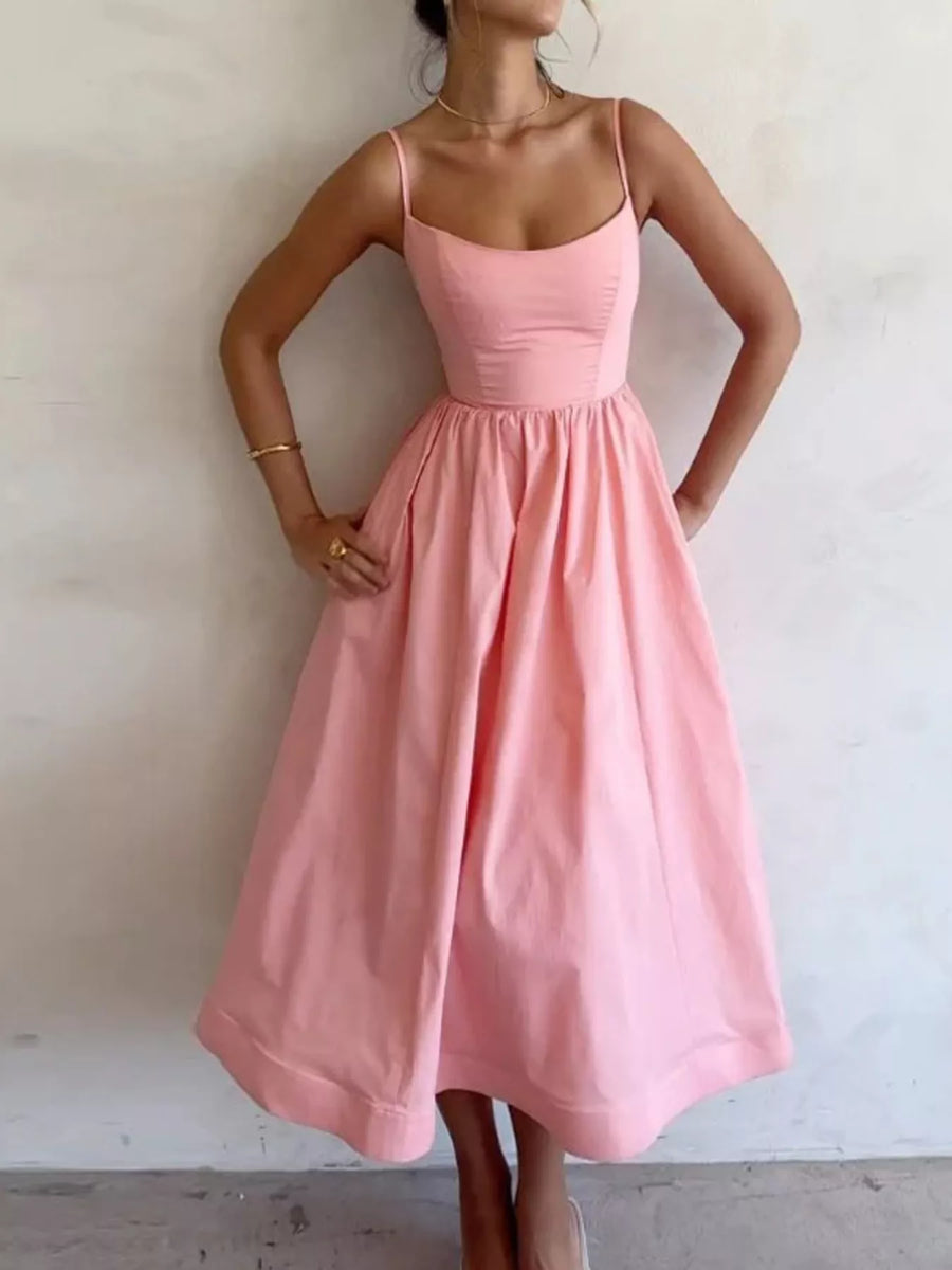 Pink dress worn by a person against a plain background