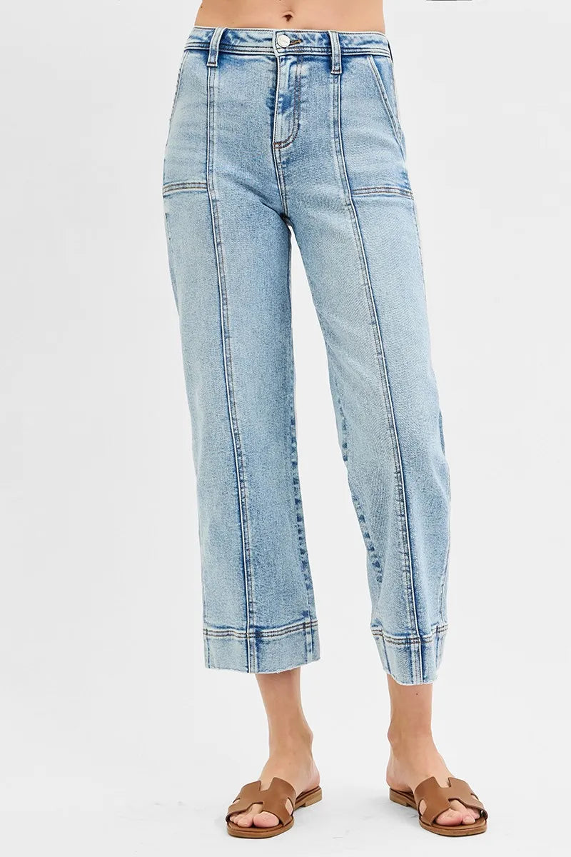 Light blue jeans worn by a person on a white background