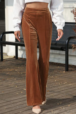 Person wearing brown corduroy pants on a wooden deck