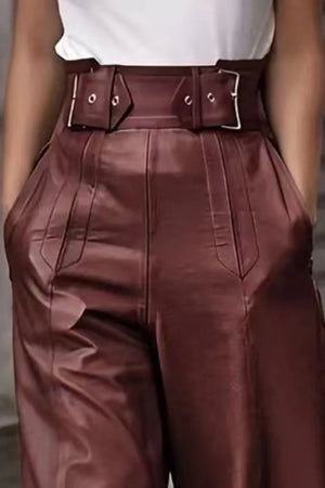 Brown leather pants with a belt worn by a person.