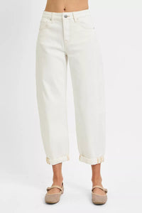 White jeans worn by a person on a white background