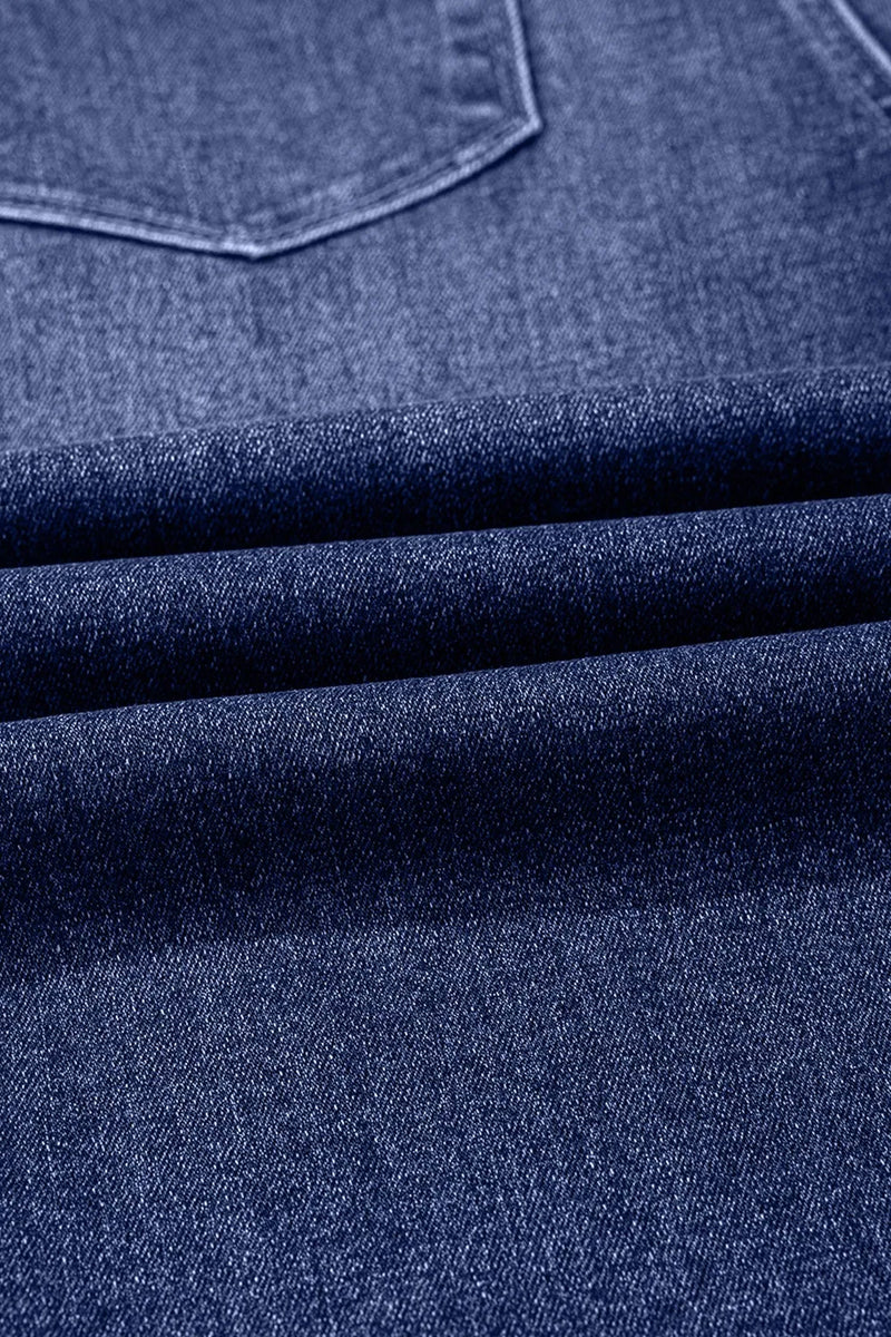 Close-up of blue denim fabric with a pocket detail
