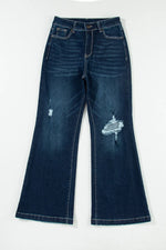 Distressed blue jeans on a white background