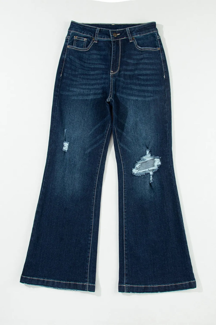 Distressed blue jeans on a white background