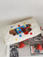 Doormat with a cartoon dog design on a white surface with magazines and strawberries.
