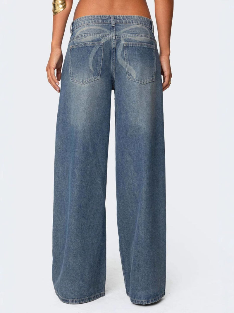 Blue jeans worn by a person on a white background