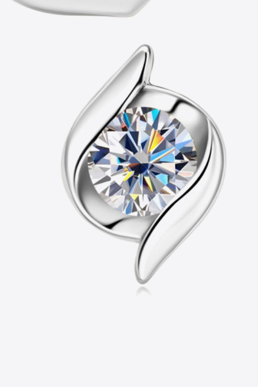 Silver earring with a clear gemstone on a white background