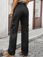 Person wearing black cargo pants on a street.