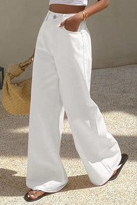 Person wearing white wide-leg pants with a neutral background