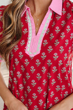 Red floral patterned top with pink trim