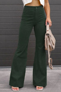 Person wearing green wide-leg pants with a neutral background