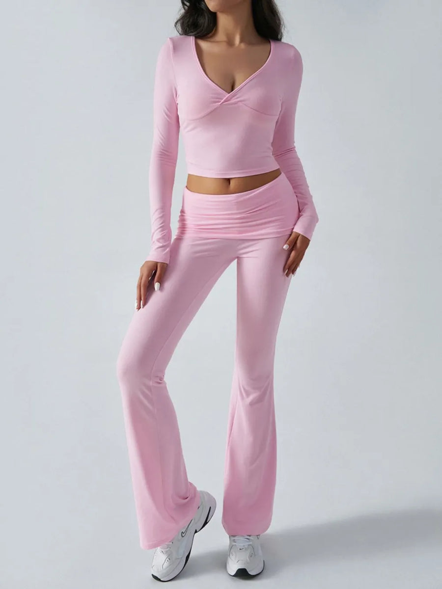 Person wearing a pink long-sleeve top and pants set on a white background