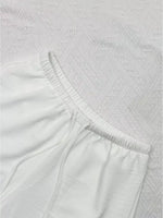 Close-up of textured white fabric with a subtle pattern