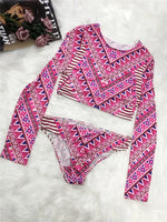 Pink and purple patterned long-sleeve top and pants on a white background