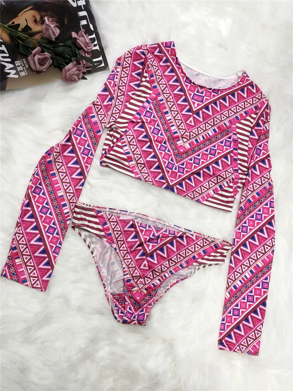 Pink and purple patterned long-sleeve top and pants on a white background