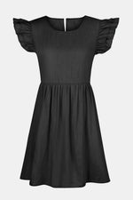 Black dress with ruffled sleeves on a light gray background