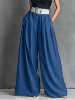Blue wide-leg pants with a white belt on a gray background