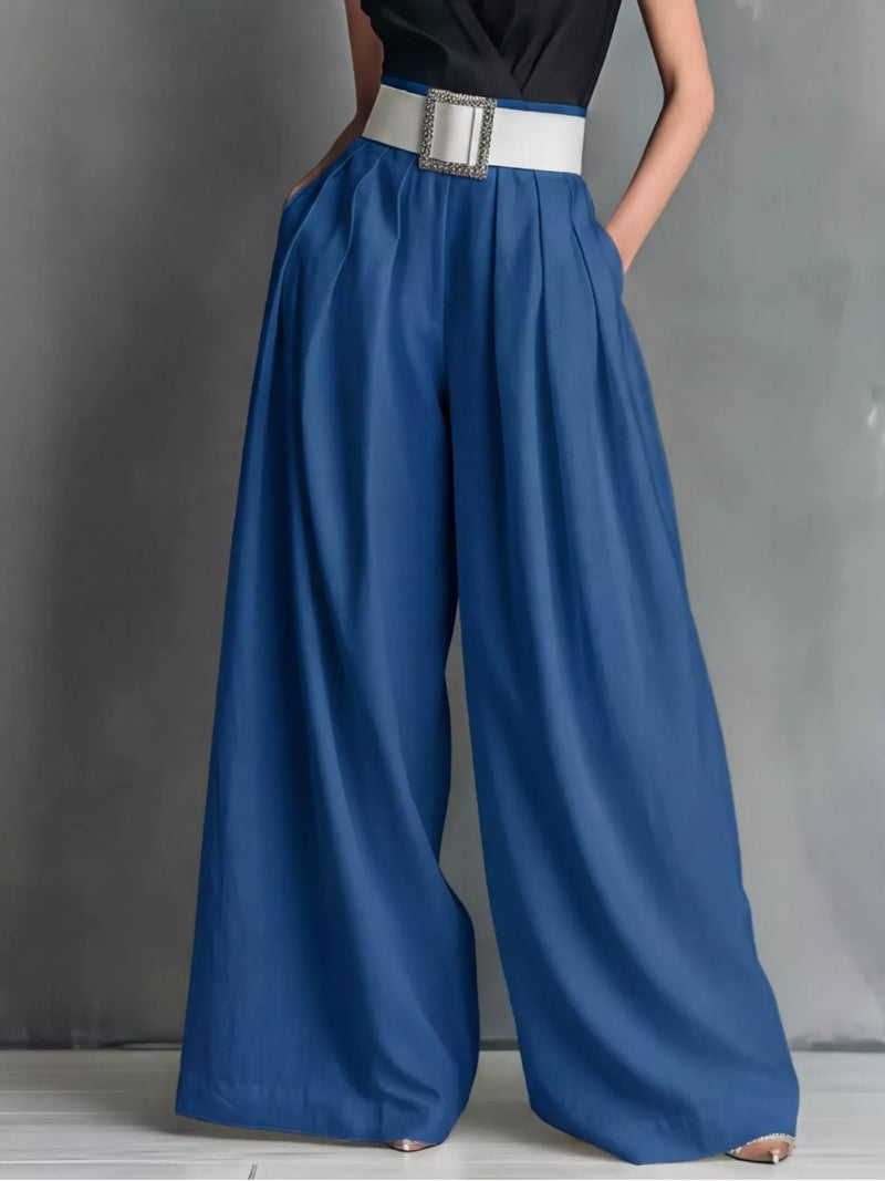 Blue wide-leg pants with a white belt on a gray background
