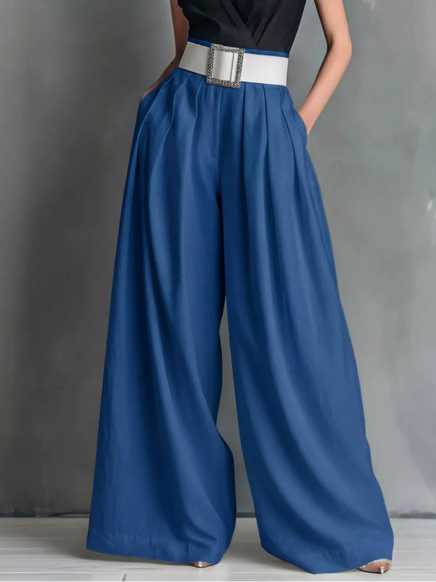 Blue wide-leg pants with a white belt on a gray background