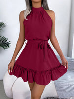 Red dress with ruffled hem worn by a person against a white background