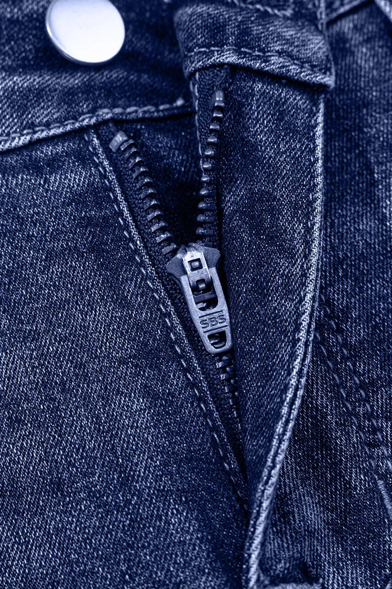 Close-up of a zipper on a blue denim jacket