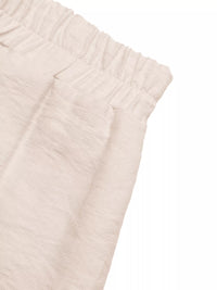 Close-up of beige textured fabric on a white background