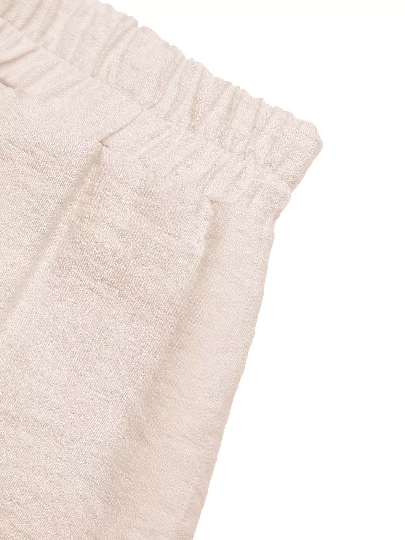 Close-up of beige textured fabric on a white background