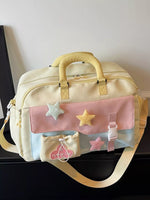 Light yellow bag with pink accents and star decorations on a dark surface.