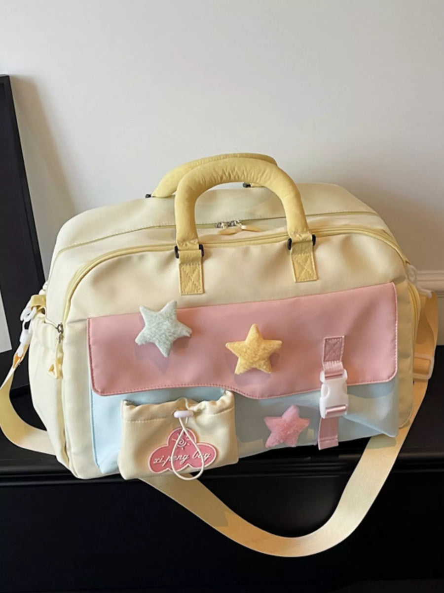 Light yellow bag with pink accents and star decorations on a dark surface.