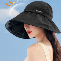 Woman wearing a black sun hat with a blue sky background