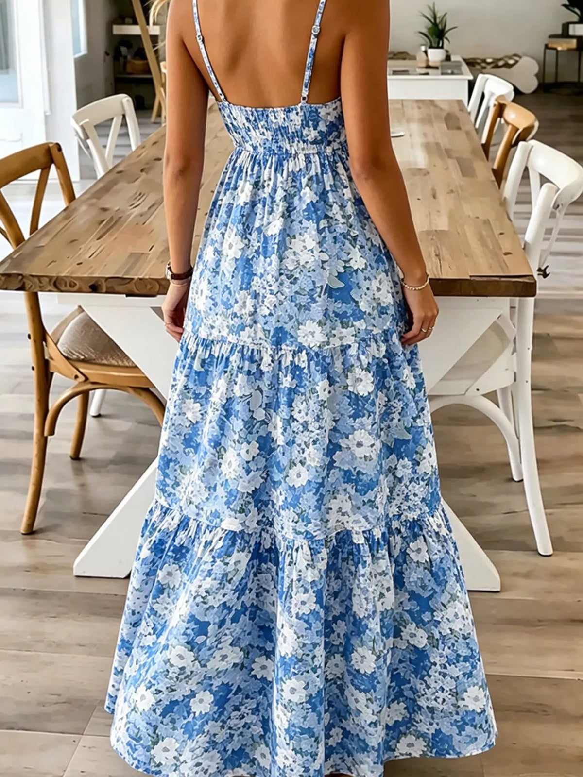 Person wearing a blue floral dress in a dining room setting