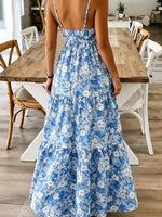 Person wearing a blue floral dress in a dining room setting