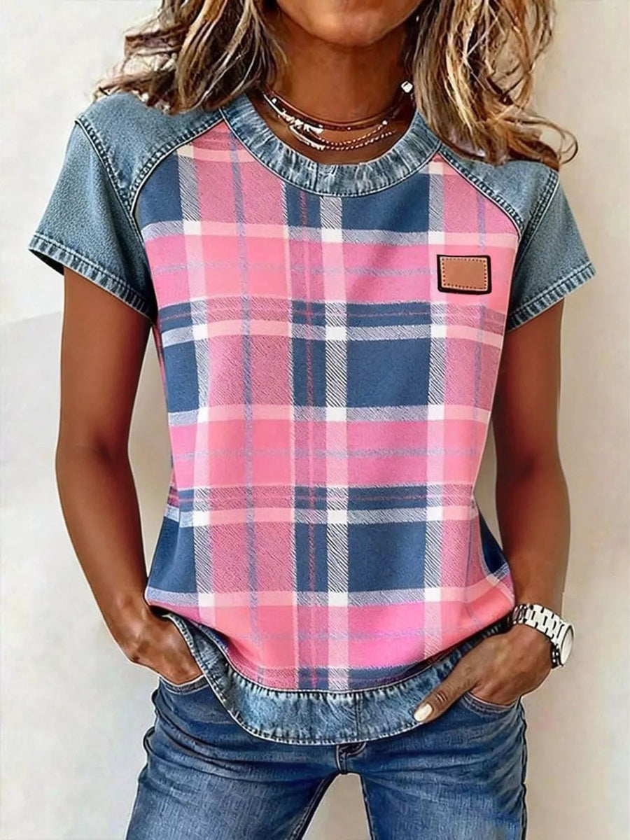 Person wearing a pink and blue plaid shirt with denim sleeves and pants.