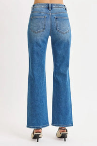 Blue jeans worn by a person on a white background