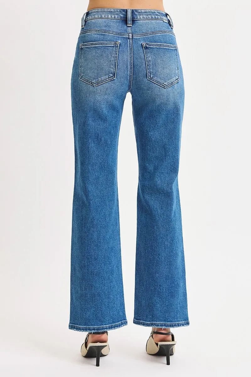 Blue jeans worn by a person on a white background