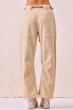Beige striped pants worn by a person on a plain background