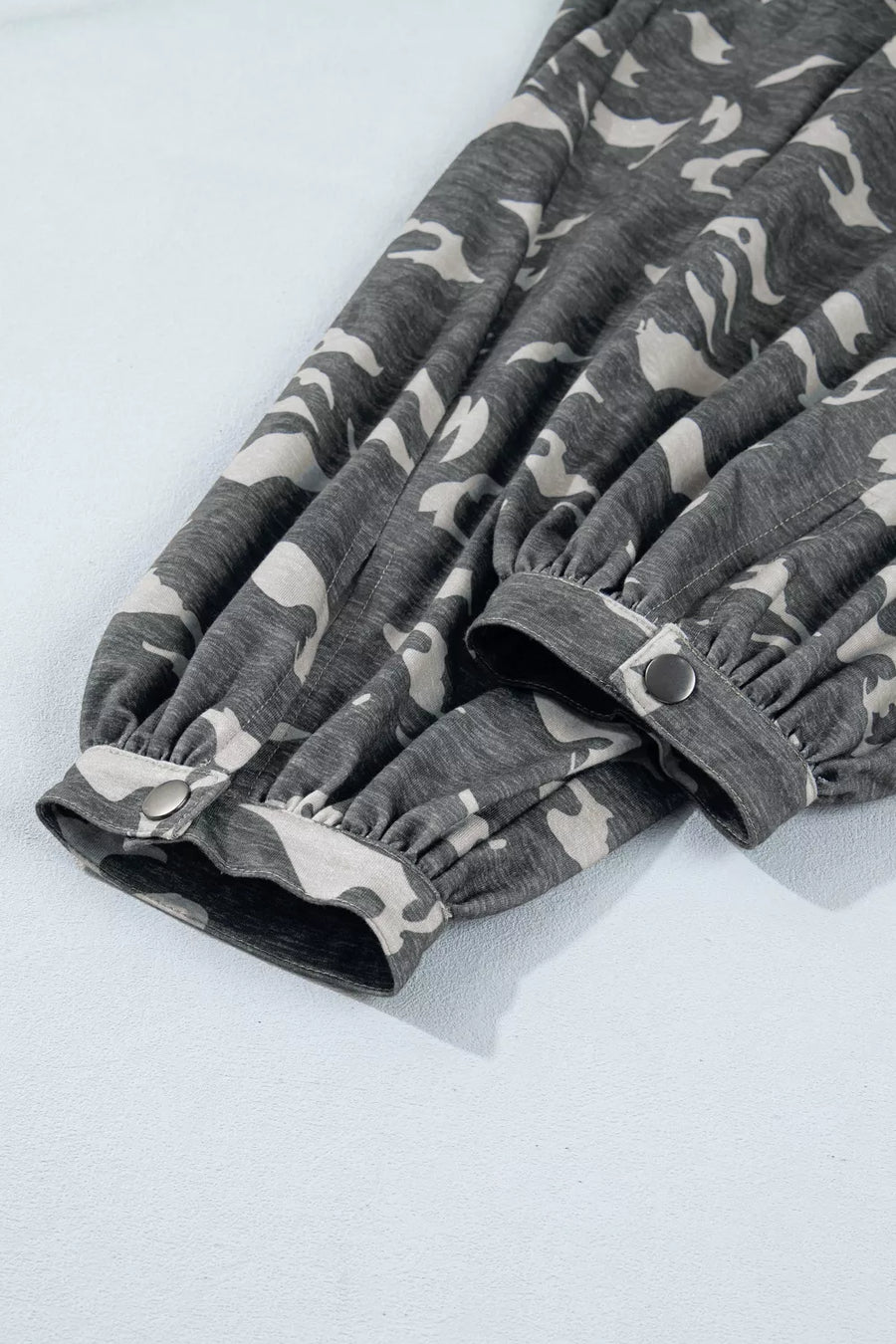 Gray camouflage-patterned pants on a light gray background