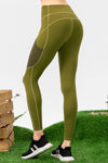 Green leggings worn by a person on a grassy background