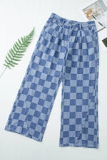 Blue checkered pants on a white background with a leaf and magazine corner.