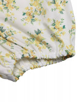 Floral patterned fabric with yellow flowers on a white background