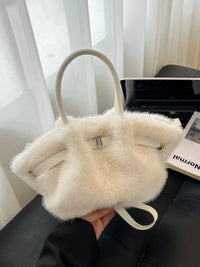 White fluffy handbag held in front of a blurred indoor background