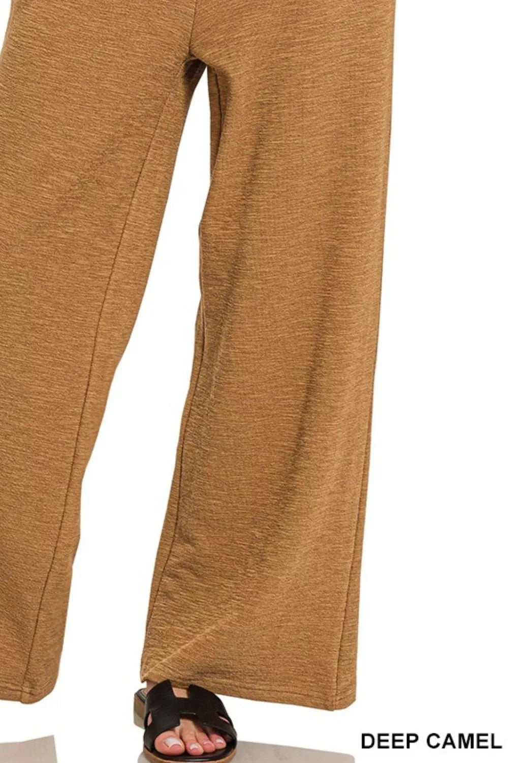Close-up of deep camel pants on a white background