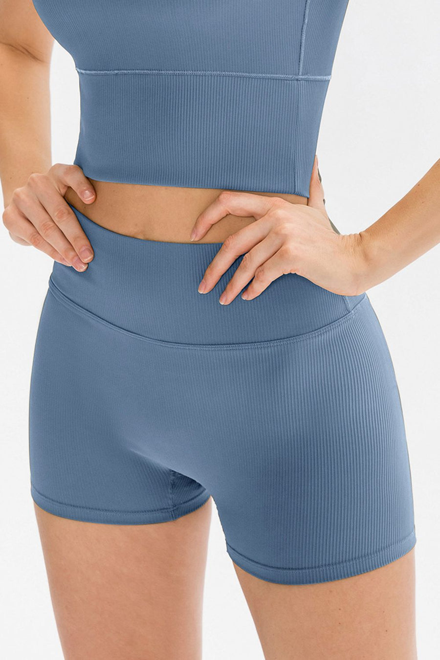 Blue athletic top and shorts set on a white background