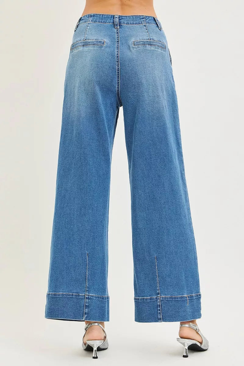 Blue jeans worn by a person on a white background