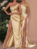 Two women wearing gold evening gowns with high slits, one against a floral background and the other against a plain background.